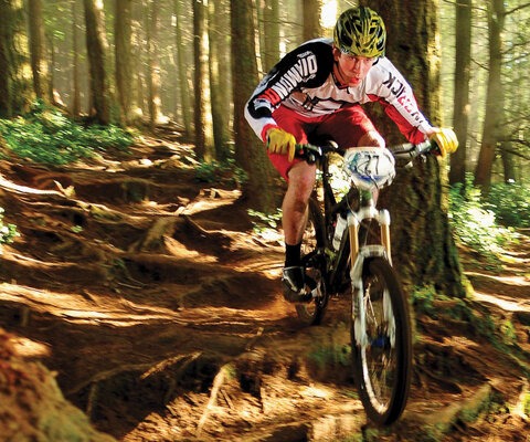 Roots aren’t a problem when you’re airing over them. Series Pro Champion Charlie Sponsel sends a techy section during the Chuckanut Enduro in Bellingham, WA.