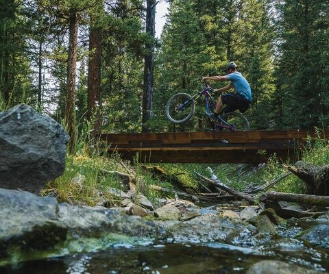 Why cruise on two wheels when you only need one? Jed Donnelly manuals a bridge on Ralph's Pass trail, surrounded by forest but not far from Big Sky's Town Center. SONY 1/500 sec, f/5.6, ISO 640.